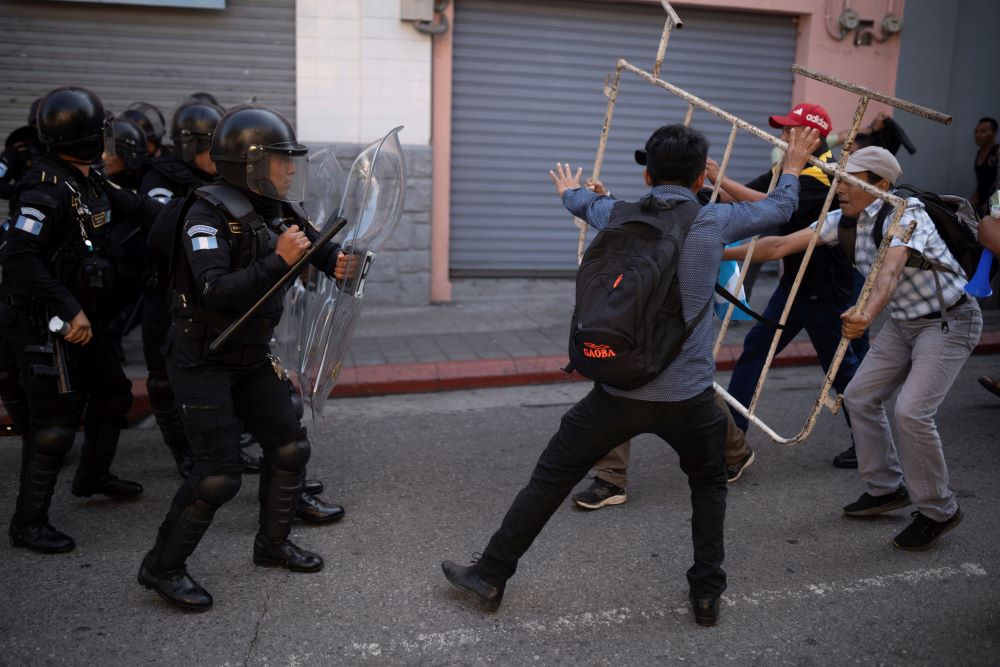 Supporters of Guatemalan President-elect Bernardo Arévalo, right, face off with police outside Congress, to protest a delay in the start of the legislative session to swear in new lawmakers on Arévalo's inauguration day in Guatemala City on Jan. 14. 