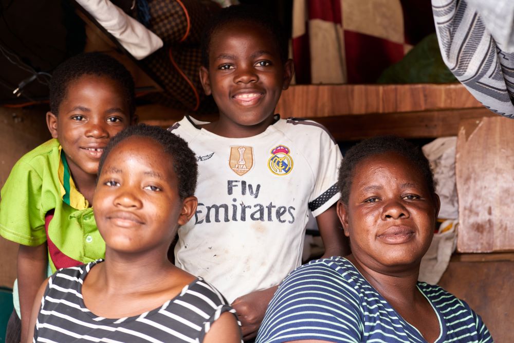 Mary Liawe and her three children pose in their apartment in the Matapi hostel in Harare, Zimbabwe.