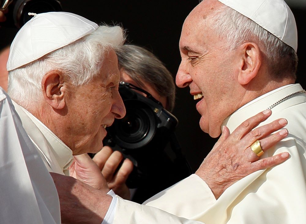 Pope Francis greets retired Pope Benedict XVI during an encounter for the elderly in St. Peter's Square at the Vatican Sept. 28, 2014. 