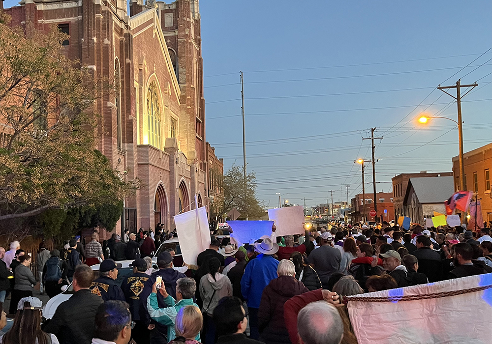 Participants in El Paso's "Do Not Be Afraid: March and Vigil for Human Dignity" await entry into Sacred Heart Catholic Parish, where a vigil was being held to mark the one-year anniversary of the 2023 Ciudad Juarez migrant detention center fire. (Evan Bednarz)