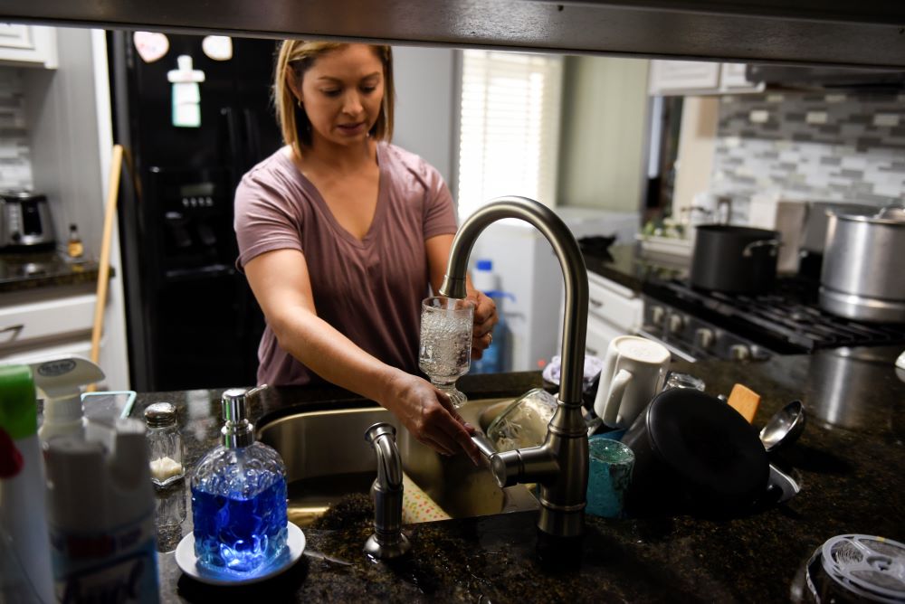 Esperanza Guerrero, 35, fills a glass full with water from her tap in Teviston, California, U.S., October 20, 2021. The town had advised not to drink the water but only use it for washing dishes and washing clothes due to contamination. Approximately 2.2 billion people worldwide (including 46 million Americans) don't have regular access to clean water -- a right Pope Francis outlined in Laudato Si'. (OSV News photo/Stephanie Keith, Reuters)