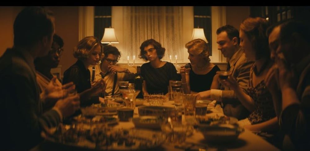 People sitting around a dining table in a scene from "Wildcat."