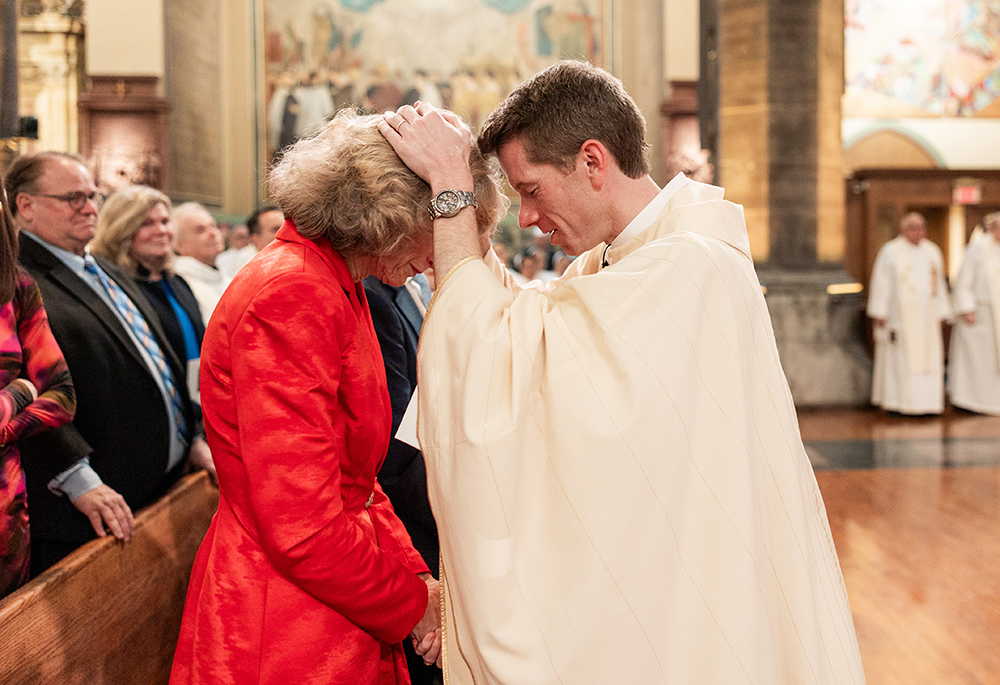 Paulist Fr. Chris Lawton blesses his mother during his ordination Mass on May 18. (Courtesy of Zachera Wollenberg)