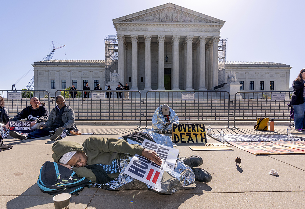 Activists demonstrate at the Supreme Court as the justices consider a challenge to rulings that found punishing people for sleeping outside when shelter space is lacking amounts to unconstitutional cruel and unusual punishment, on Capitol Hill April 22 in Washington. (AP photo/J. Scott Applewhite)
