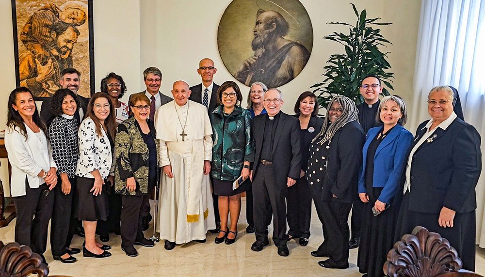 Pope Francis poses for a photo with delegates from U.S. community organizing groups, including Holy Family Sr. Alicia Costa (right), after a private meeting in his Vatican residence, Casa Santa Marta, Sept. 14, 2023. (CNS/Courtesy of West/Southwest Industrial Areas Foundation)