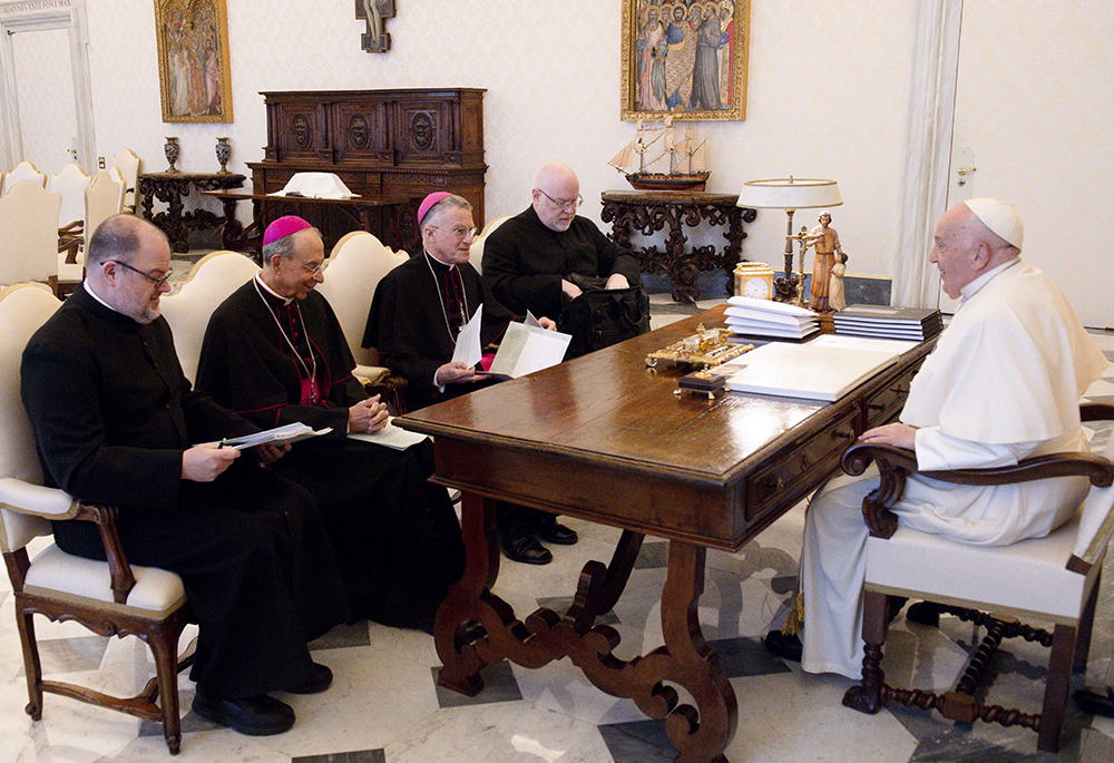 Pope Francis holds his regular spring meeting with the officers of the U.S. Conference of Catholic Bishops April 18 in the library of the Apostolic Palace at the Vatican. Seated from the left are: Fr. Michael J.K. Fuller, general secretary; Archbishop William Lori of Baltimore, vice president; Archbishop Timothy Broglio, president and head of the U.S. Archdiocese for the Military Services; and Fr. Paul B.R. Hartmann, associate general secretary. (CNS/Vatican Media)