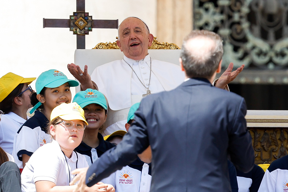 Pope Francis shares a laugh with Italian actor, Roberto Benigni, as Benigni gives the closing talk in St. Peter's Square at the Vatican May 26, 2024, wrapping up the first World Children's Day held May 25-26. (CNS/Lola Gomez)