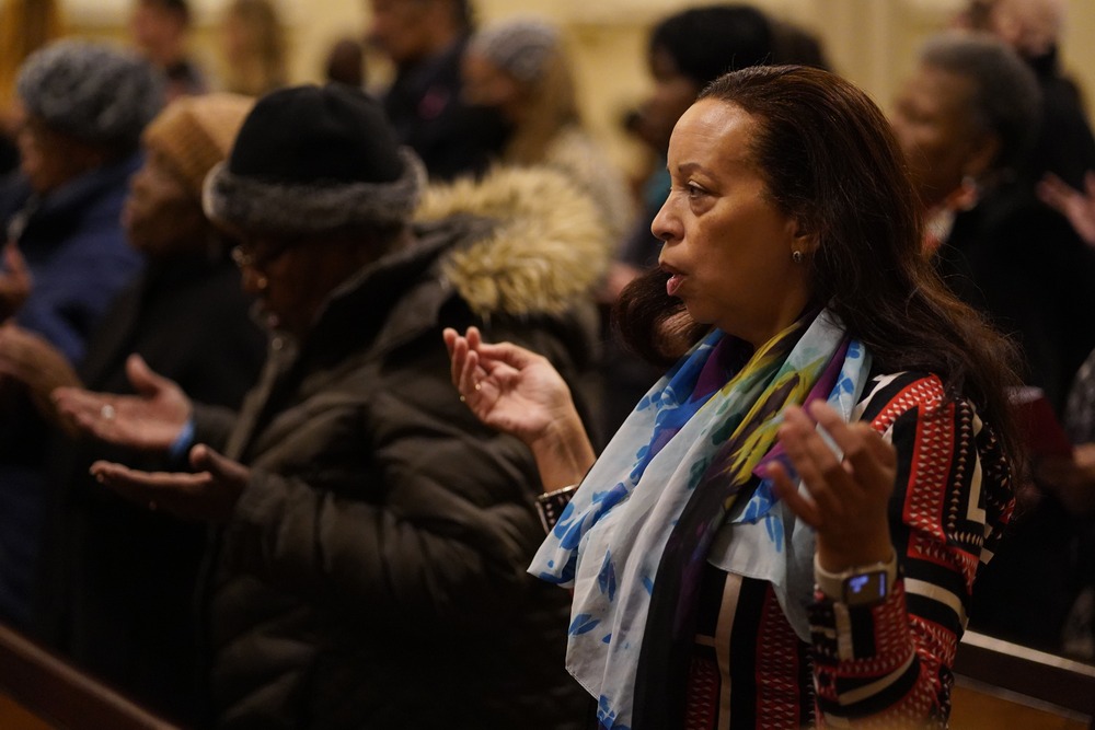 People raise their hands in prayer