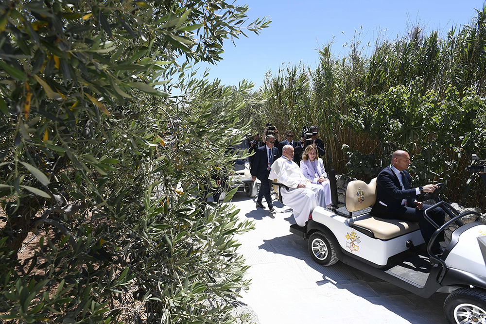 Pope Francis rides in a golf cart with Italian Prime Minister Giorgia Meloni after arriving by helicopter at the Group of Seven summit in Borgo Egnazia, in Italy's southern Puglia region, June 14, 2024. (CNS/Vatican Media)