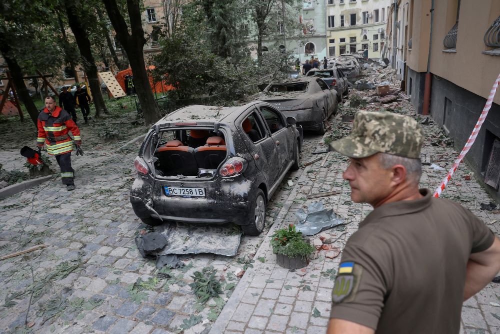 Emergency personnel examine the area around a residential building that was hit by a Russian missile strike in Lviv, Ukraine, July 6, 2023. The missile attack killed at least four people, injured 37 others and destroyed hundreds of buildings.