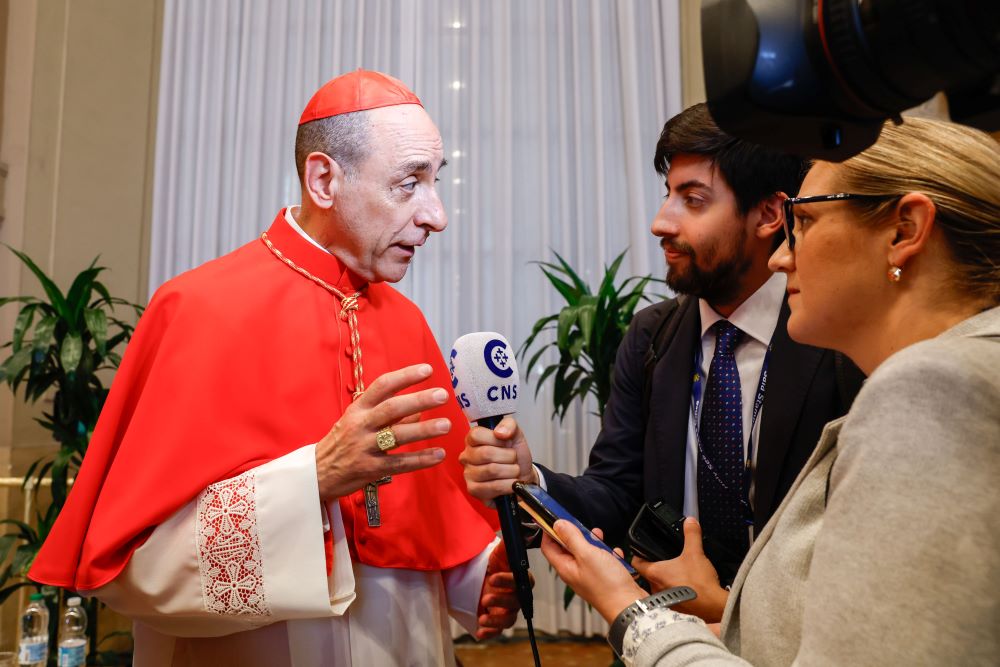 Cardinal Víctor Manuel Fernández talks to reporter.