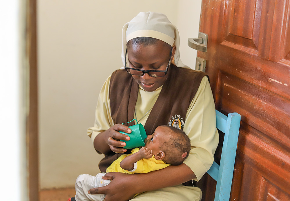 Sr. Judith Auma, a member of the Little Sisters of St. Francis of Assisi, feeds a baby on Jan. 18 at St. Josephine Bakhita Babies Home in Busia, a town in western Kenya. (GSR photo/Doreen Ajiambo)