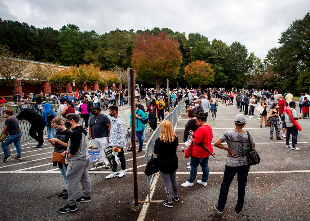 Hundreds of people wait in line for early voting in Marietta, Ga., on Oct. 12, 2020. 