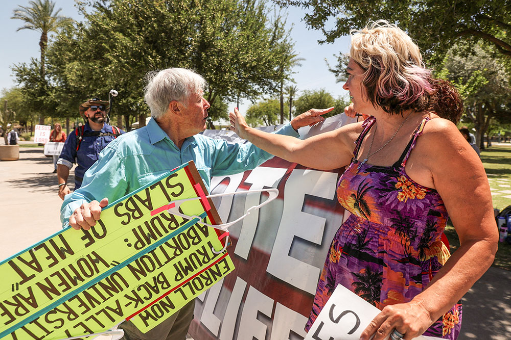 A pro-life protester and a supporter of legal abortion argue outside the Arizona State Capitol in Phoenix as the state Senate votes to repeal its near total ban on abortion May 1. (OSV News/Reuters/Liliana Salgado)