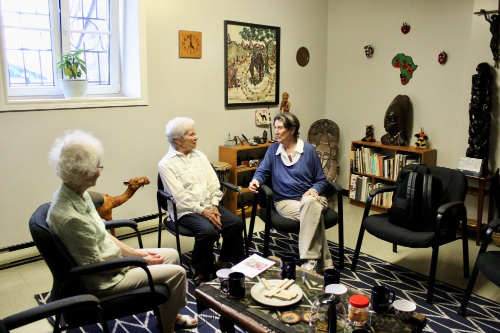 The sisters visit with a visitor from France. 