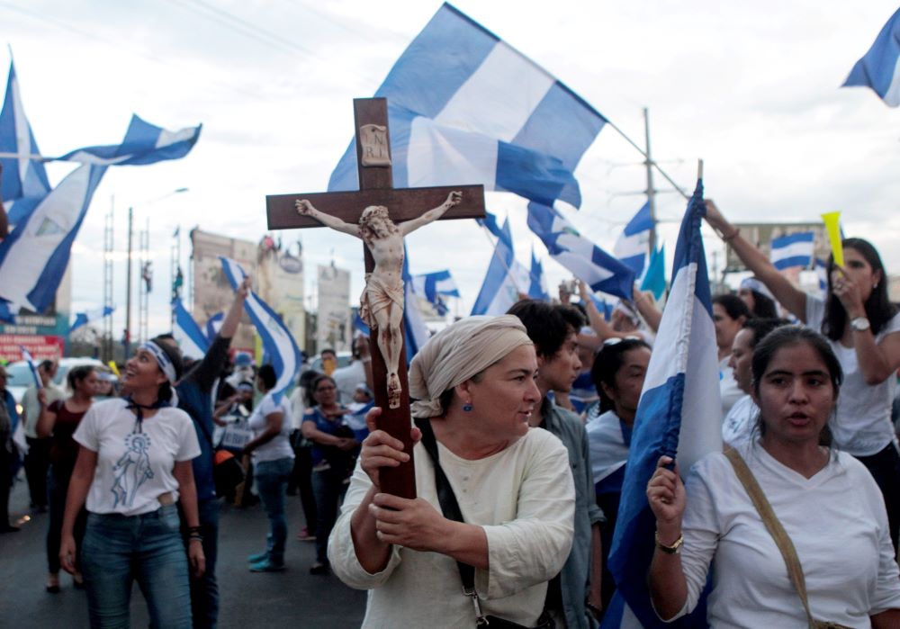 A demonstrator holds a crucifix during a protest against Nicaraguan President Daniel Ortega's government in Managua May 15, 2018. 