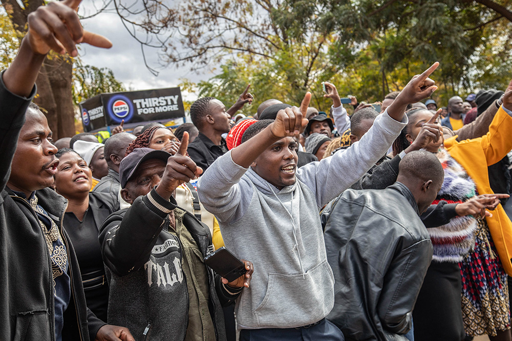 Opposition supporters protest outside a court in Harare, Zimbabwe,, June 27. The protesters were angered by a magistrate's decision to deny bail to close to 80 activists arrested mid-June for allegedly meeting without official clearance. (AP/Aaron Ufumeli)