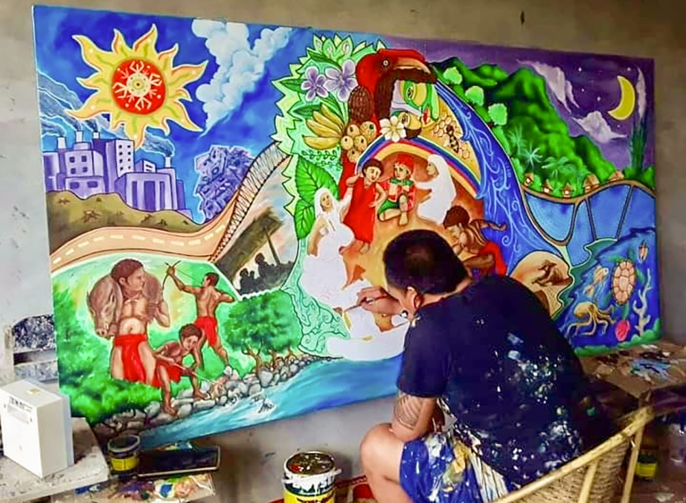 Franciscan Br. Christopher Villanueva works on a large painting. (Courtesy of Order of Friars Minor)