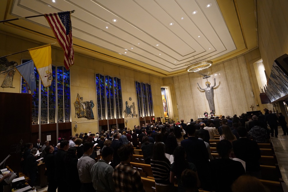 Sanctuary of Holy Family shown from rear, filled to capacity. 