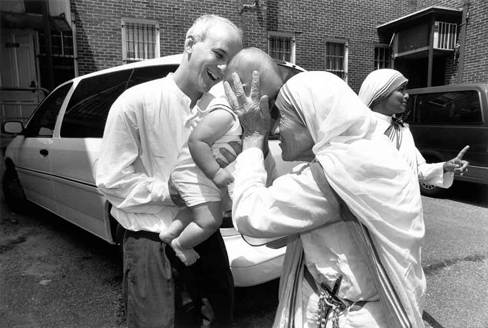 St. Teresa of Kolkata greets a baby in this archival photo. (OSV News/Carmel Communications)