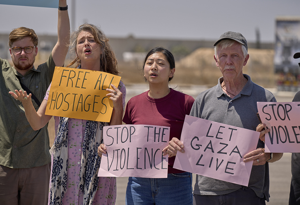 A delegation of U.S. Christians hold an Aug. 18 prayer vigil at the Kerem Shalom crossing on the border between Israel and Gaza. The group came to the Middle East to accompany threatened Christians and other Palestinians and call for a cease-fire in Gaza. (OSV News/Paul Jeffrey)