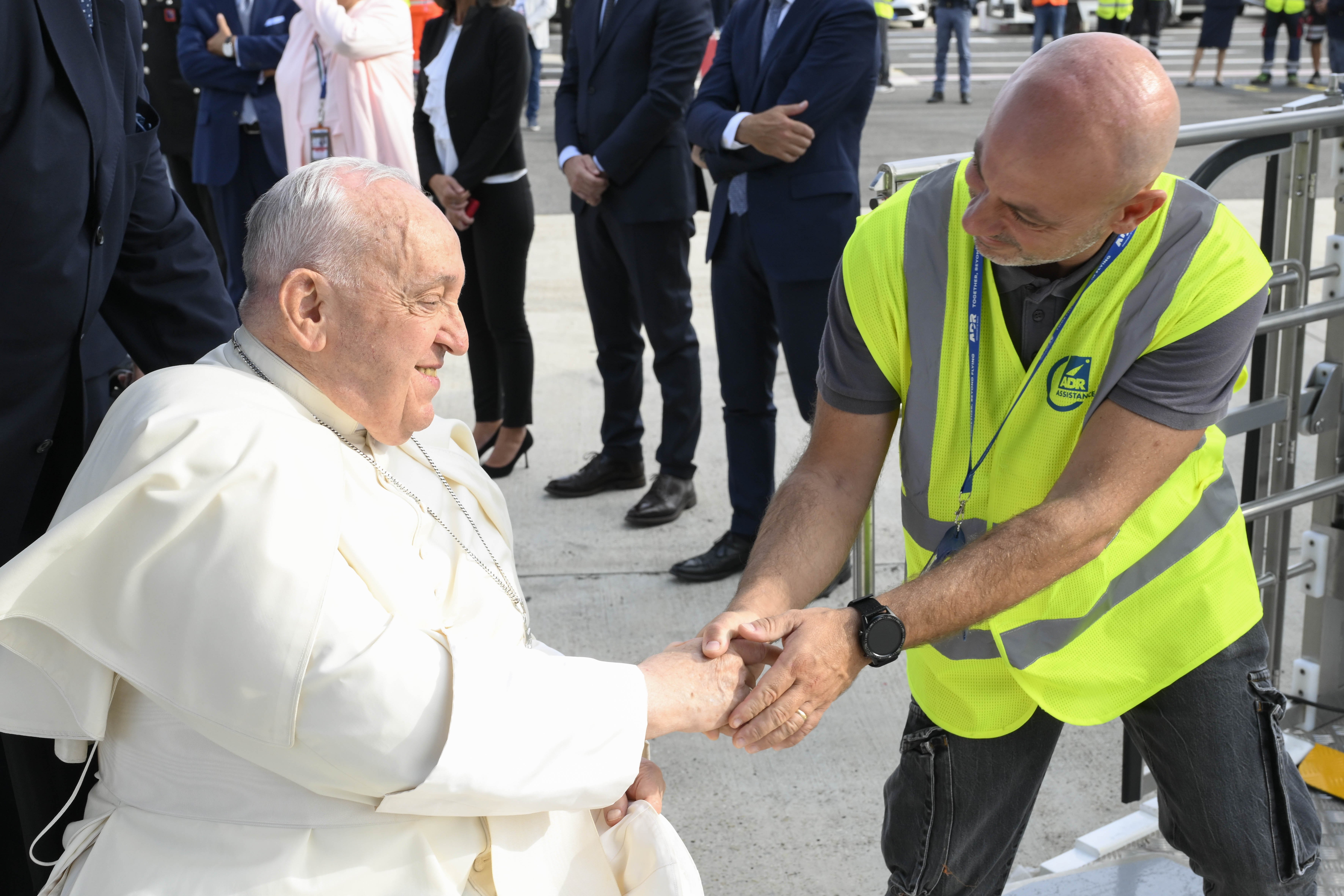 Pope Francis, seated in a wheelchair, greets an airport worker as he prepares to board an ITA flight at Rome’s Fiumicino airport Sept. 2, 2024, for an overnight flight to Jakarta, Indonesia. His 45th international trip and the longest of his papacy, will take him to Indonesia, Papua New Guinea, Timor-Leste and Singapore. (CNS photo/Vatican Media)