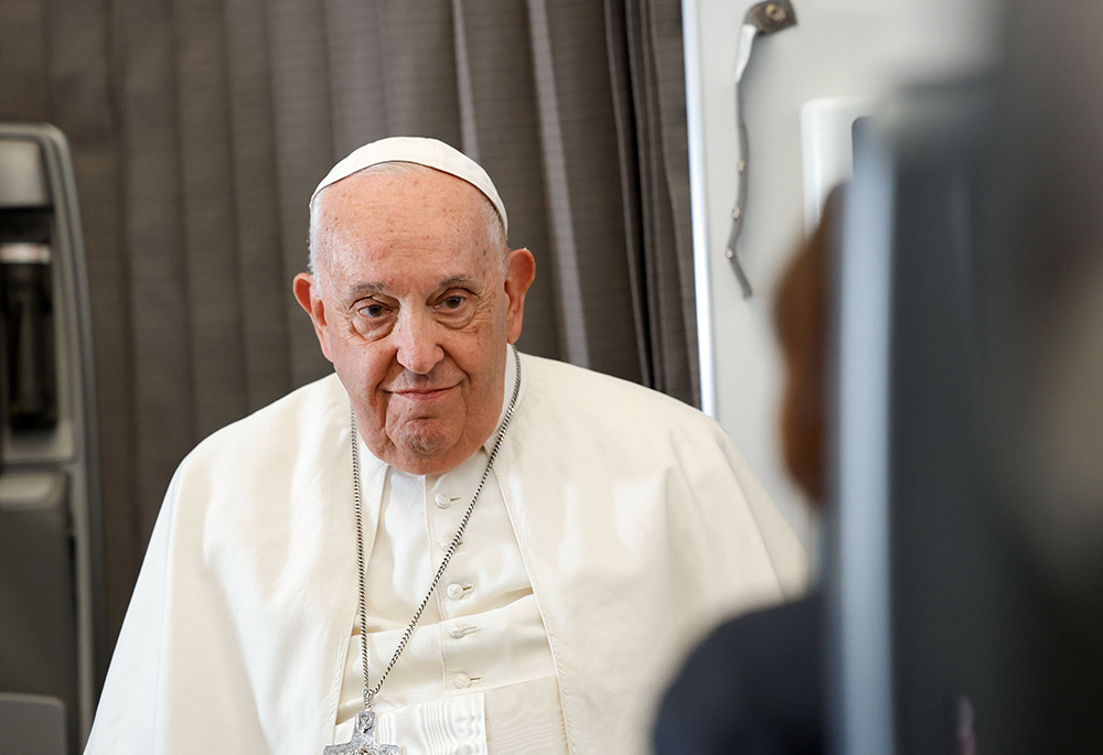 Pope Francis listens to a question from a journalist aboard his flight back to Rome Sept. 13, after visiting Indonesia, Papua New Guinea, Timor-Leste (or East Timor) and Singapore. It was his 45th and longest foreign trip. (CNS/Lola Gomez)