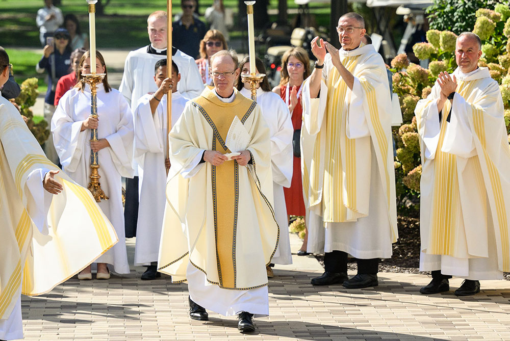 Holy Cross Fr. Robert Dowd acknowledges applause from concelebrants after the Mass celebrating his inauguration as the University of Notre Dame's 18th president in Notre Dame, Indiana, on Sept. 13. (OSV News/University of Notre Dame/Matt Cashore)