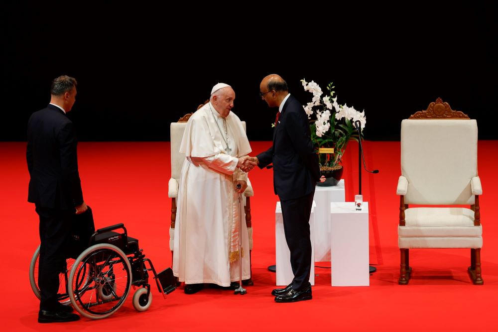 Pope Francis shakes hands with Singapore President Tharman Shanmugaratnam.