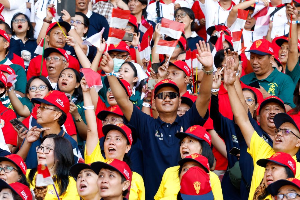 People cheer as Pope Francis arrives at the Gelora Bung Karno Stadium in Jakarta, Indonesia, to celebrate Mass.