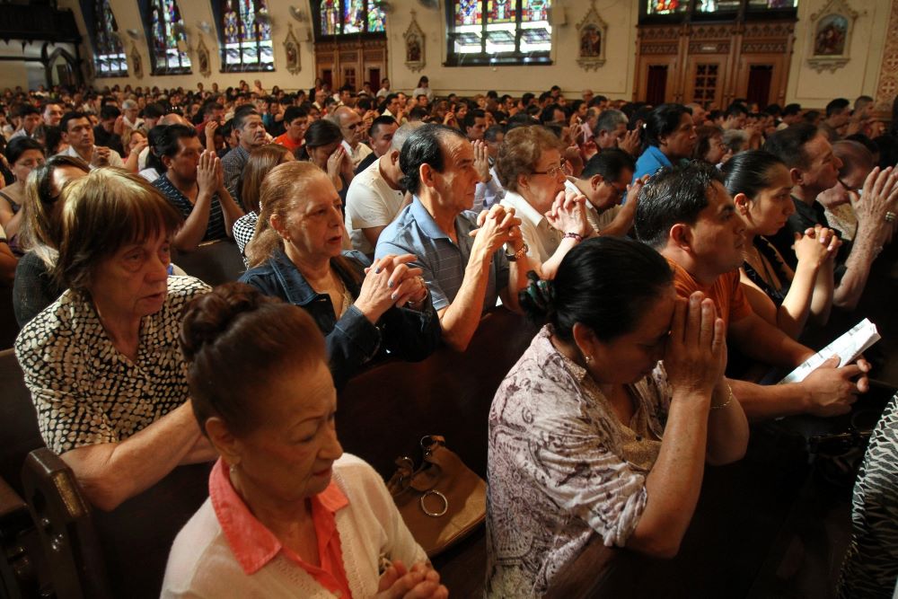 People pray during a Mass for immigration reform at Our Lady of Sorrows Church in the Corona neighborhood of the New York borough of Queens. 