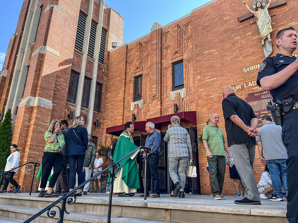 Msgr. Jamie Gigantiello, pastor of Our Lady of Mount Carmel-Annunciation Parish, greets parishioners outside Our Lady of Mount Carmel in Brooklyn, New York, Sept. 22. (Sean Piccoli)