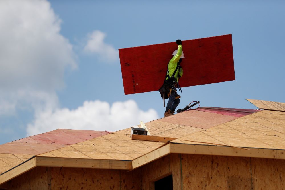 A carpenter works on building new townhomes in Tampa, Fla., May 5, 2021. 