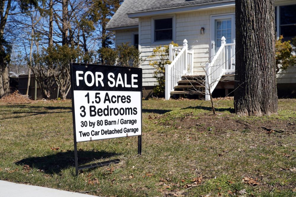 A real estate sign is seen outside a house for sale in Stony Brook, N.Y., March 5, 2021. 