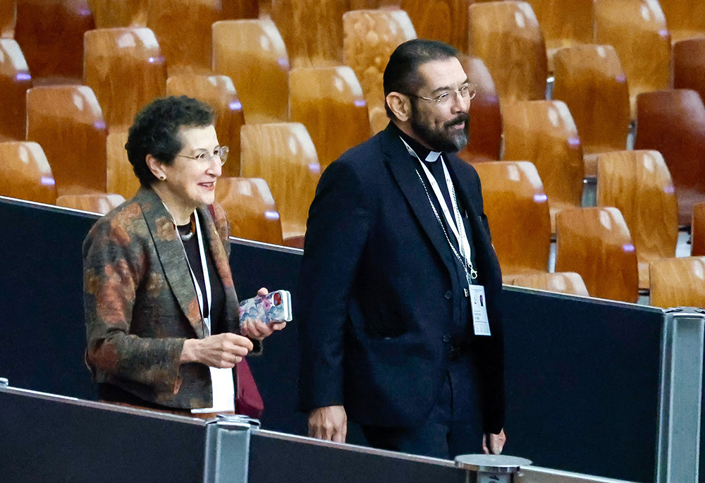 Susan Pascoe, a synod member from Australia, and Bishop Daniel Flores of Brownsville, Texas, arrive for a session of the assembly of the Synod of Bishops in the Vatican's Paul VI Audience Hall on Oct. 17, 2023. (CNS/Lola Gomez)