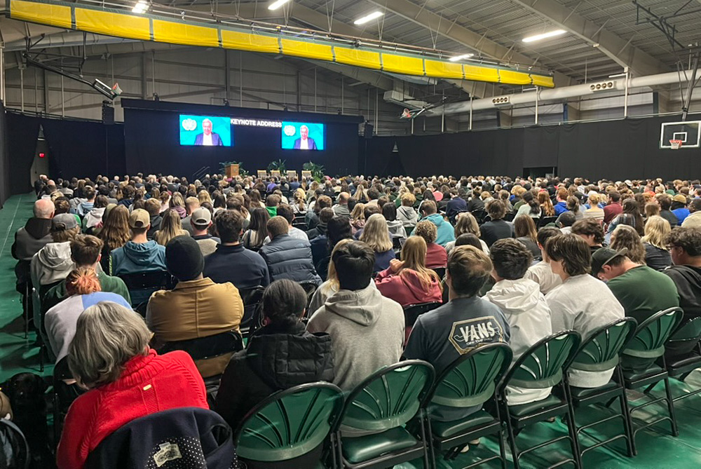 Students, staff and visitors at Siena College in Loudonville, New York, watch a video message from U.N. Secretary-General António Guterres in the Marcelle Athletic Center Oct. 10 at the opening of the Franciscan school's symposium on integral ecology. (Courtesy of Siena College)