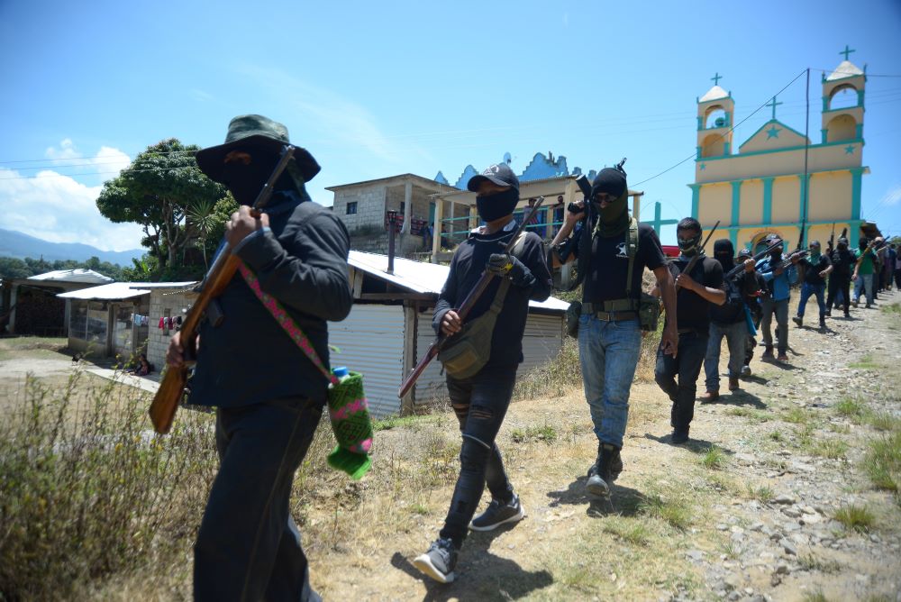 Vigilantes of "El Machete," an armed group, march in formation after an assembly with indigenous communities near a church in Chiapas, Mexico, July 18, 2021. 