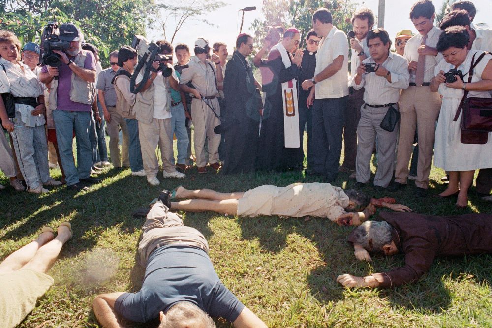 San Salvador Archbishop Arturo Rivera Damas and others view the bodies of those slain at Central American University in El Salvador Nov. 16, 1989. 