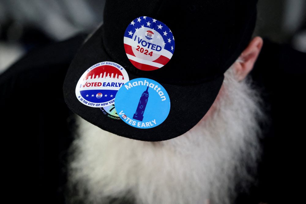 A man wears a hat with stickers on Election Day, Nov. 5, for the U.S. presidential election in the Manhattan borough of New York City. 