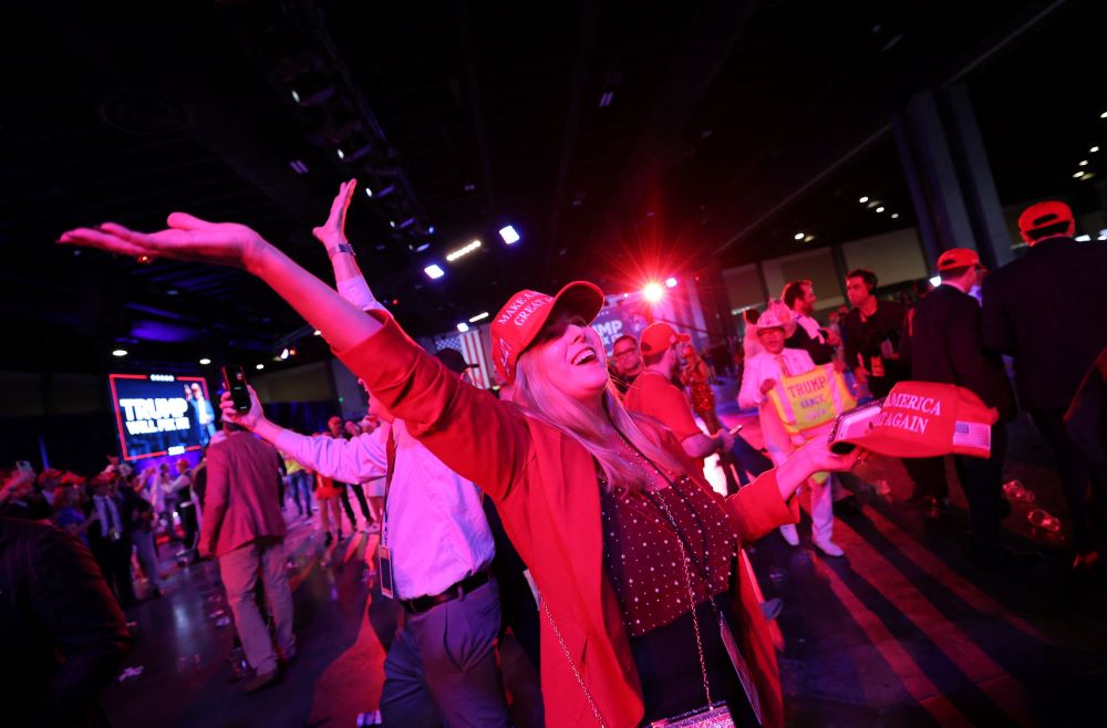 A supporter of Republican President-elect Donald Trump celebrates at his victory rally.