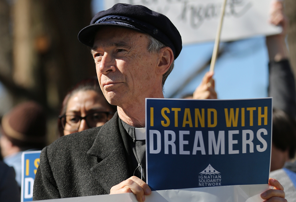 Jesuit Fr. Thomas Reese listens to speakers during a "Catholic Day of Action for Dreamers" protest to press Congress to protect "Dreamers" outside the U.S. Capitol Feb. 27, 2018, in Washington. (CNS/Bob Roller)