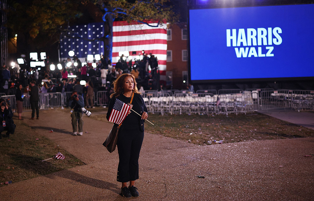 An attendee holds a U.S. flag at the conclusion of an Election Night rally for Democratic presidential nominee U.S. Vice President Kamala Harris at Howard University in Washington Nov. 6. Harris' Republican rival, Donald Trump, was elected the 47th president of the United States. (OSV News/Reuters/Daniel Cole)