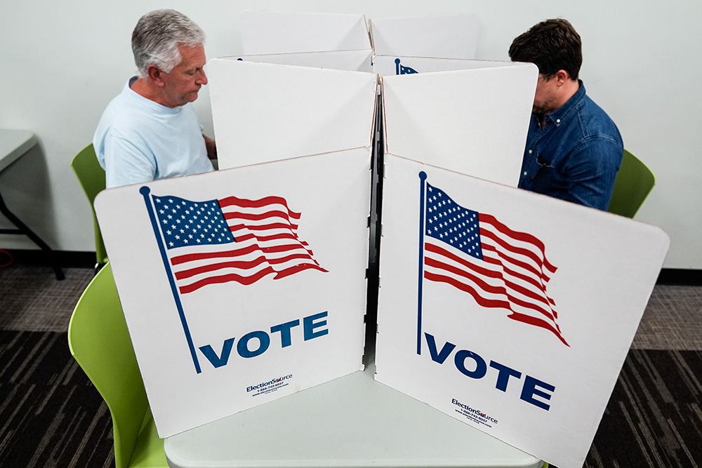 People mark their ballots at the polling place at Tysons-Pimmit Regional Library in Falls Church, Va., Oct. 31. (AP/Stephanie Scarbrough)