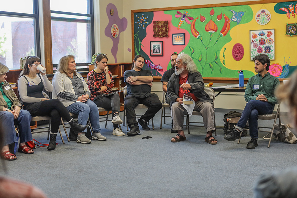 Jeromiah Taylor, right, and Brian Terrell, second from right, co-facilitate a roundtable discussion at the Peter Maurin Conference, which was held at St. Gregory's Hall in Chicago Sept. 6-8. (Mark Franzen)