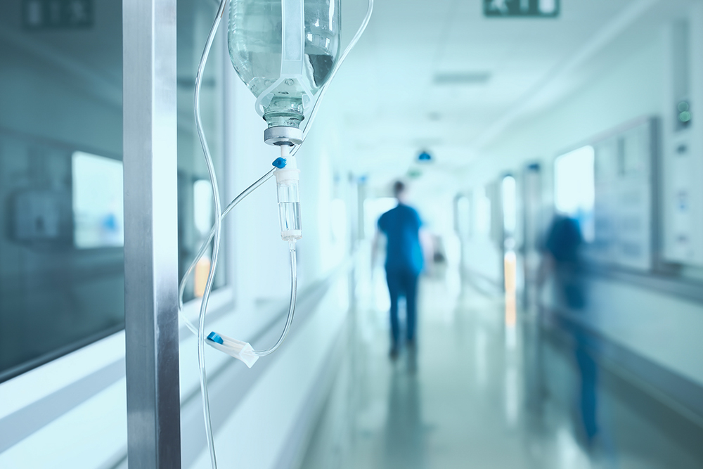 Medical workers walk in a hospital hallway in an illustration photo. (Dreamstime/Sudok1)