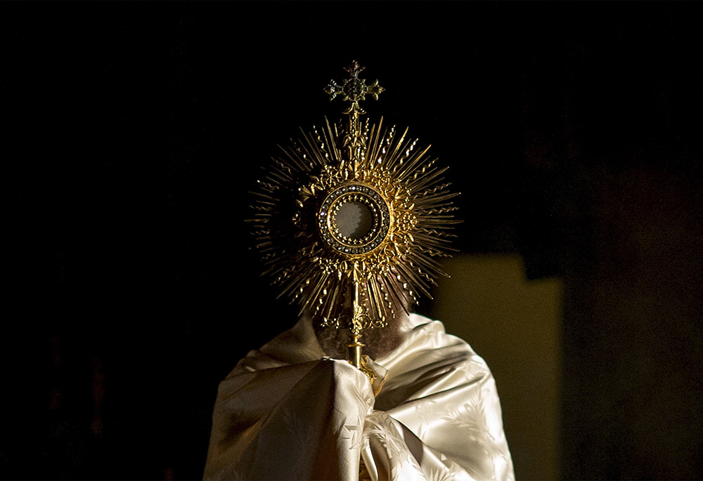 A priest participates in the adoration of the Eucharist at the Church of Our Lady of Good Counsel Sept. 5, 2015, in New York City. (CNS/Reuters/Brendan McDermid)