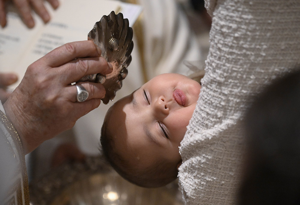 Pope Francis baptizes a baby during Mass in the Sistine Chapel at the Vatican on Jan. 7, 2024, the feast of the Baptism of the Lord. (CNS/Vatican Media)