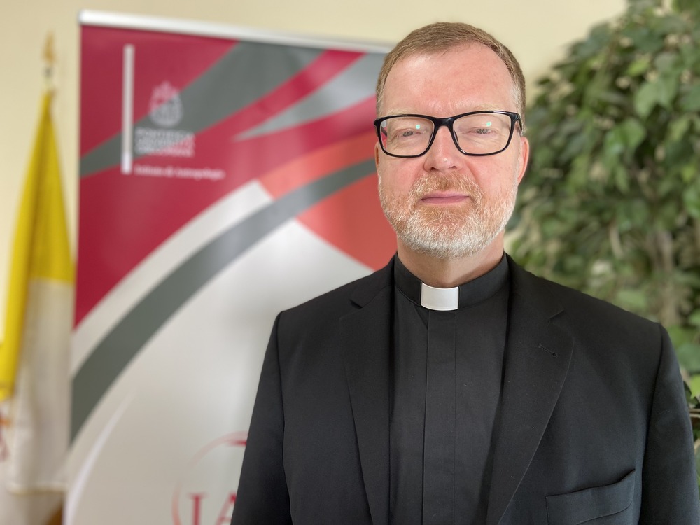 Portrait of Zollner wearing black clerics and facing camera.