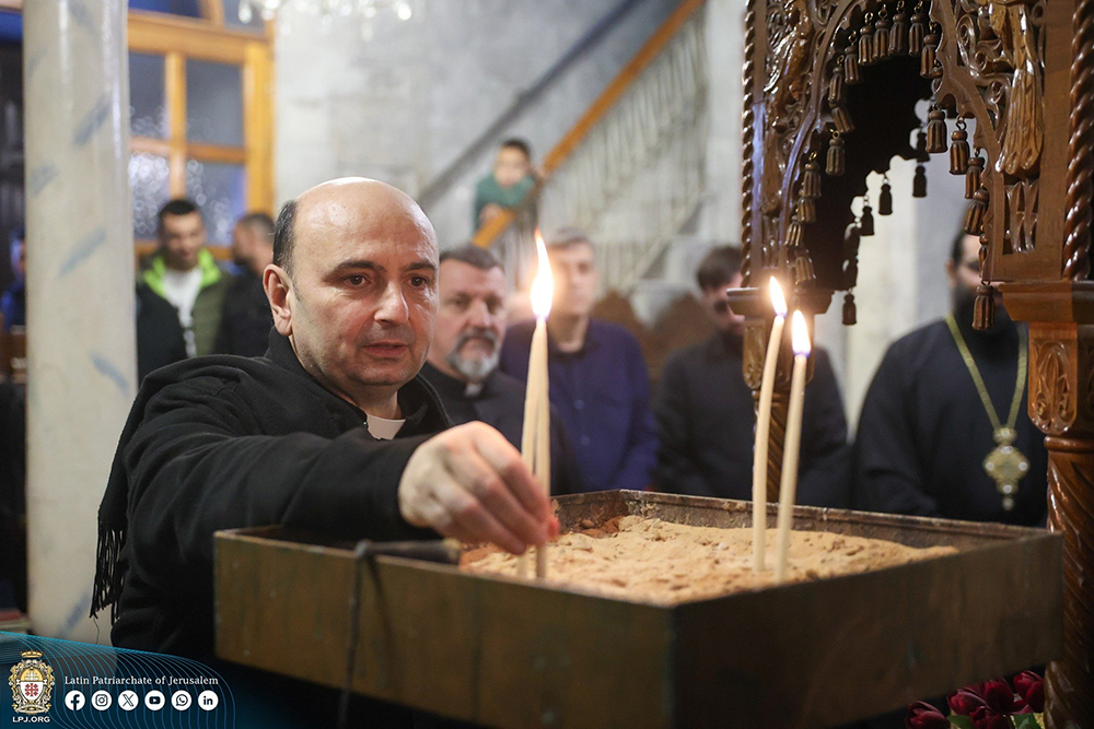 Fr. Gabriel Romanelli, parish priest of Holy Family Church in Gaza City, lights a candle Dec. 22, 2024. (OSV News/Courtesy of Latin Patriarchate of Jerusalem)