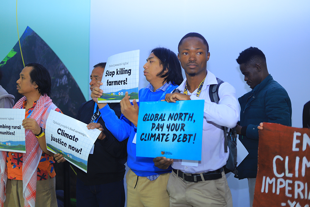 A climate activist takes part in a demonstration Nov. 18 at the COP29 United Nations climate change conference in Baku, Azerbaijan. (EarthBeat photo/Doreen Ajiambo)